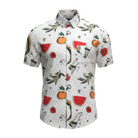 Project Good Apparel white short-sleeve button-up shirt with a repeating pattern of fruits, olive branches, doves, and crescent moons.